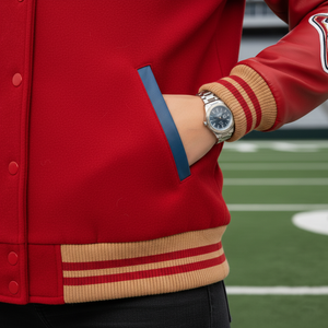 Detail view of green leather sleeve construction with red and brown striped ribbed cuffs