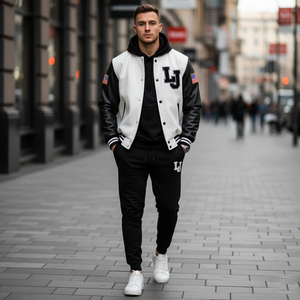 Man wearing a varsity jacket with 'LJ' lettering on a city street.