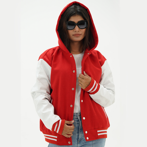 A woman wearing a red and white letterman jacket with leather arms and a hoodie. The jacket has a standing collar, ribbed cuffs, and side pockets.