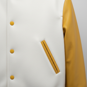 Close-up of a white jacket with yellow buttons and a sleeve on a light gray background