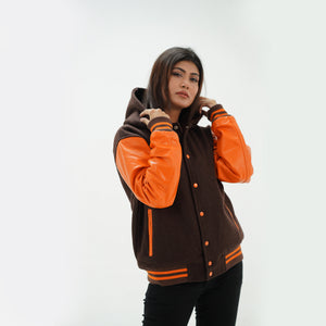 Detail shot of old gold leather sleeve with brown striped ribbed cuffs on hooded letterman jacket