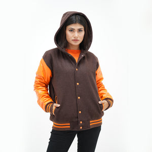 Three-quarter angle of women's mustard letterman jacket with hood showing old gold leather sleeves and ribbed waistband