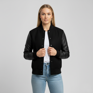 Woman wearing a black jacket over a white shirt and blue jeans on a gray background