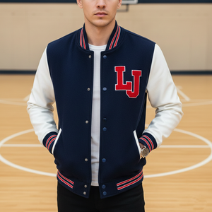 Person wearing a navy and white letterman jacket with a red 'LJ' logo on a basketball court.