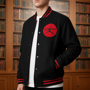 Person wearing a black varsity jacket with a red Micheal Jordan logo in front of a bookshelf.