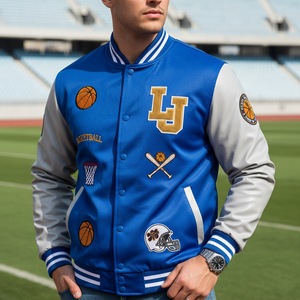 Person wearing a blue and gray varsity jacket with patches on a sports field