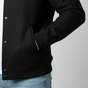 Close-up of black letterman jacket ribbed sleeves and premium wool construction detail