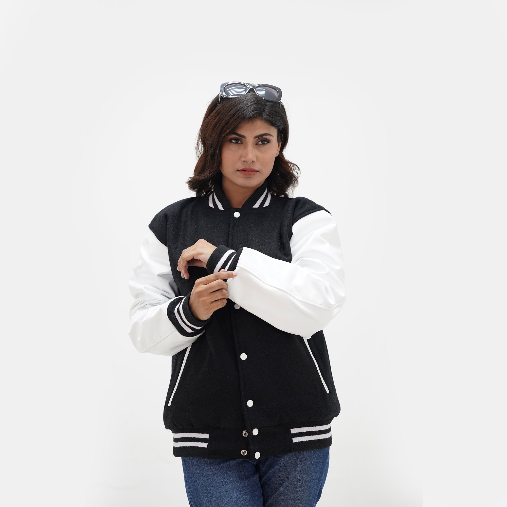 Black varsity jacket women close-up - showing ribbed collar and cuff construction with black and white striped trim detail