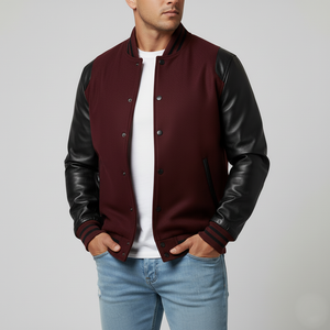Man wearing a maroon varsity jacket with black leather sleeves on a plain background