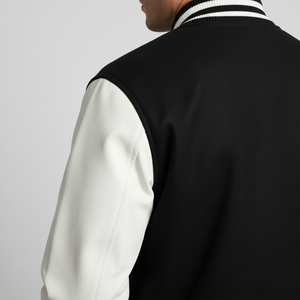 Black and white varsity jacket on a plain background 