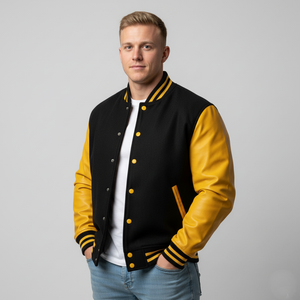 Man wearing a black and yellow varsity jacket on a gray background