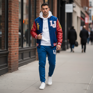 Man wearing a red and blue varsity jacket with 'LJ' logo on a city street.