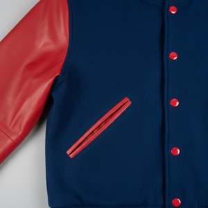 Blue jacket with red leather sleeves and buttons on a white background