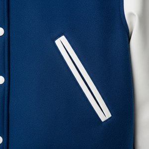 Navy blue sleeveless jacket with a white zipper detail on a light gray background