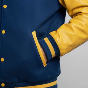 Navy and yellow varsity jacket with a gray background