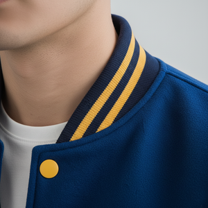 Close-up of a blue jacket with yellow accents on a gray background