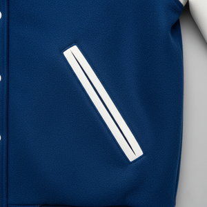 Close-up of a blue jacket with a white stripe on a gray background
