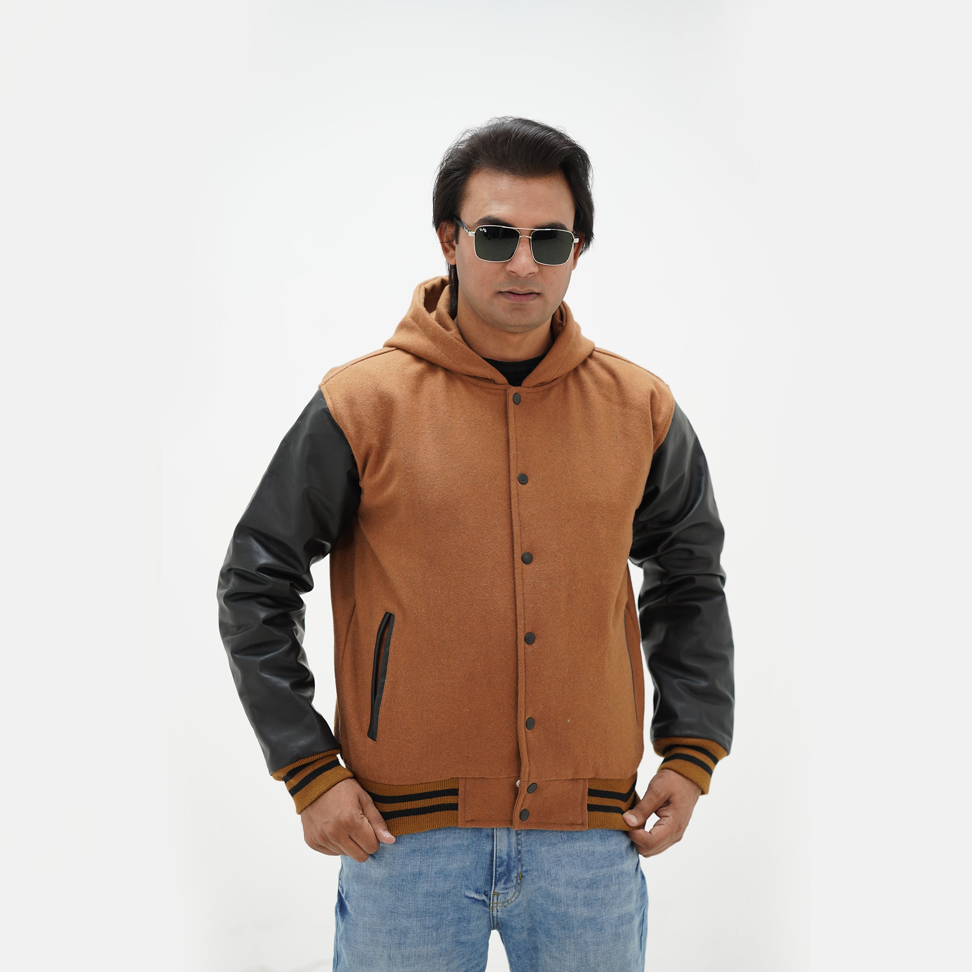 Side angle of brown and black hooded varsity jacket highlighting genuine cowhide leather sleeves and wool body design