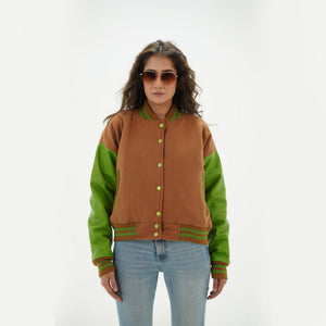 Close-up detail of brown and parrot green varsity jacket featuring brown wool and parrot green leather sleeve junction with ribbed collar trim