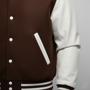 Brown and white varsity jacket on a gray background