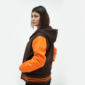 brown women's varsity jacket with hood side angle featuring old gold leather raglan sleeves and ribbed trim