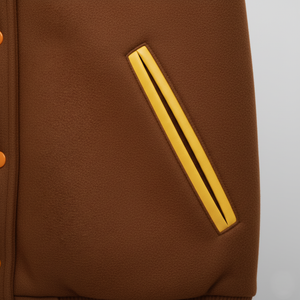 Brown jacket with a yellow stripe on a gray background