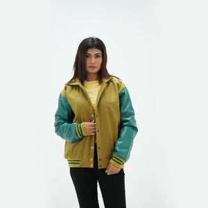 Close-up of camel women's letterman hoodie drawstring hood and ribbed collar with green leather sleeve contrast detail