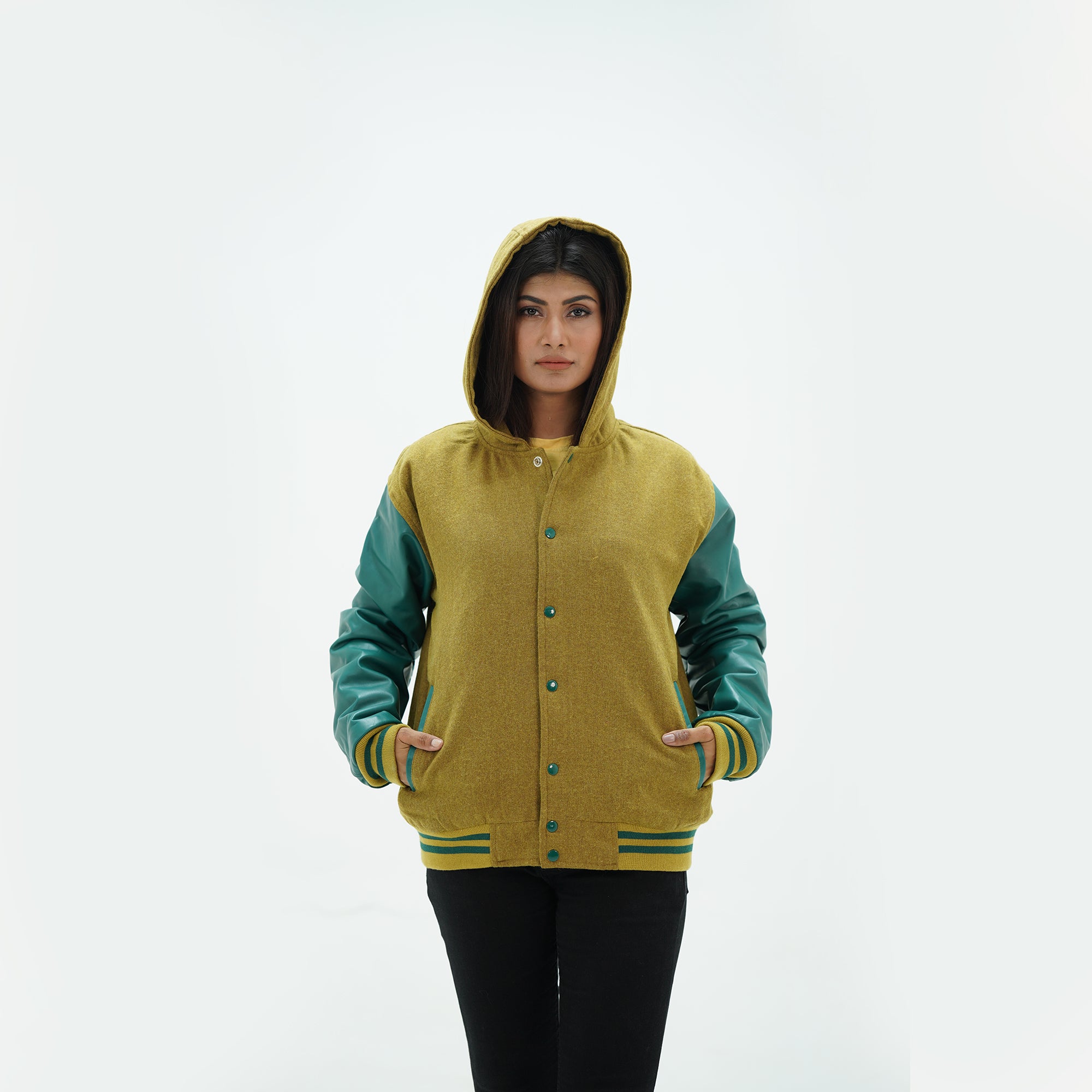 Detail shot of green leather sleeve with camel and white striped ribbed knit cuffs on women's hooded varsity jacket