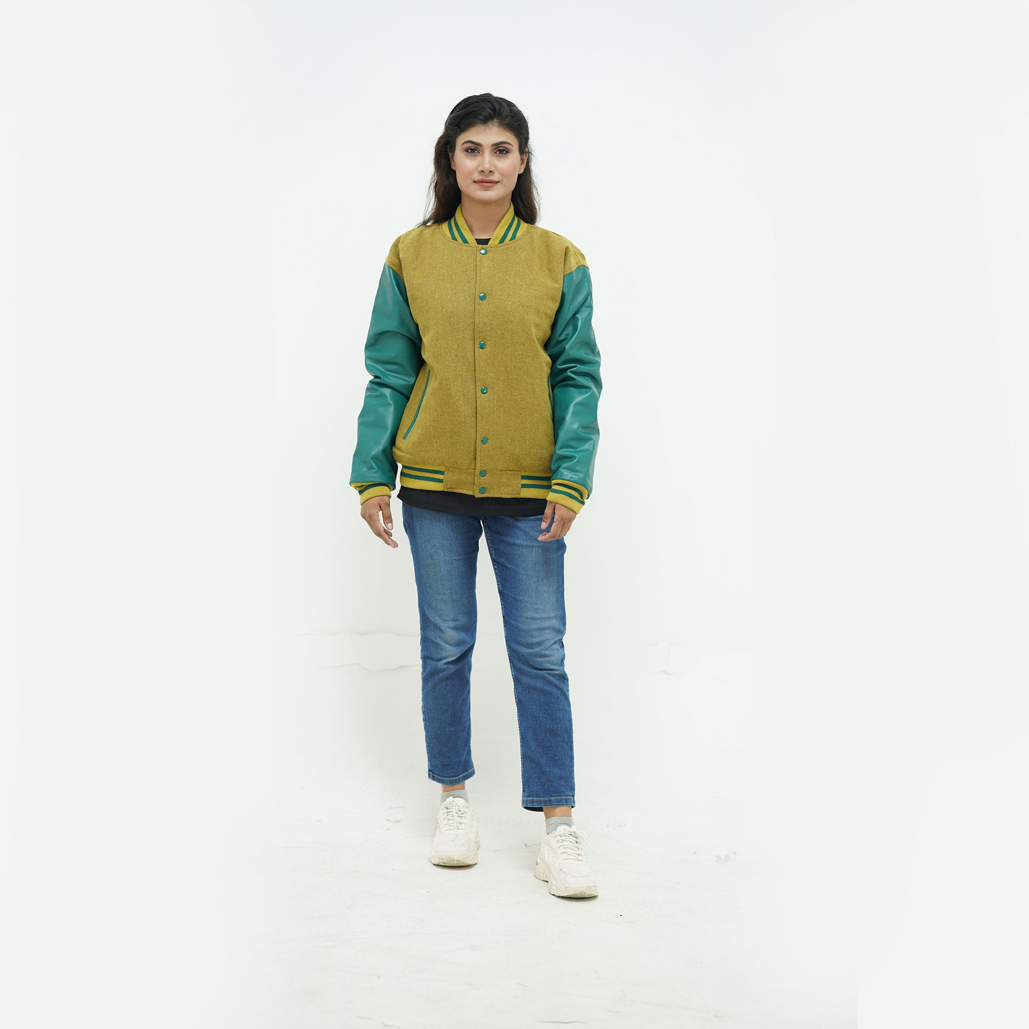 zoomed-out view of women's camel wool varsity jacket with green leather sleeves displaying ribbed hem and premium Melton wool construction
