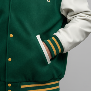 Green varsity jacket with gold buttons and trim on a gray background 