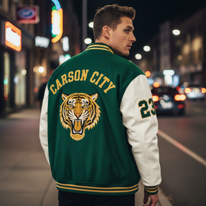 Man wearing a green and white letterman jacket with a tiger emblem and 'Carson City' text on a city street at night.