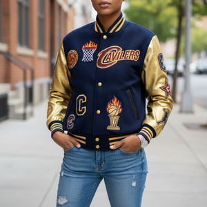 Person wearing a Cleveland Cavaliers letterman jacket on a city street.