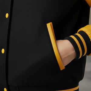 Black letterman jacket with yellow accents sleeve-rib-close-up on a mannequin against a neutral background