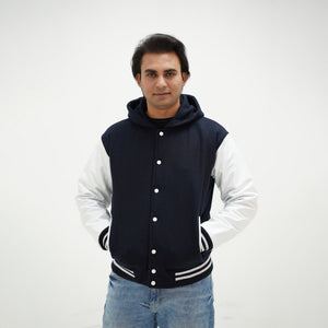 Detailed view of dark blue and white hooded varsity jacket making classic statement with wool body and leather sleeves