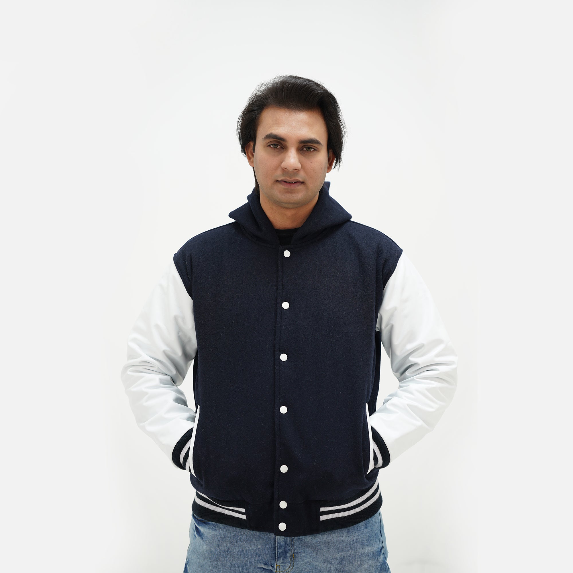Front view of dark blue and white hooded varsity jacket featuring wool body and genuine leather sleeves classic statement
