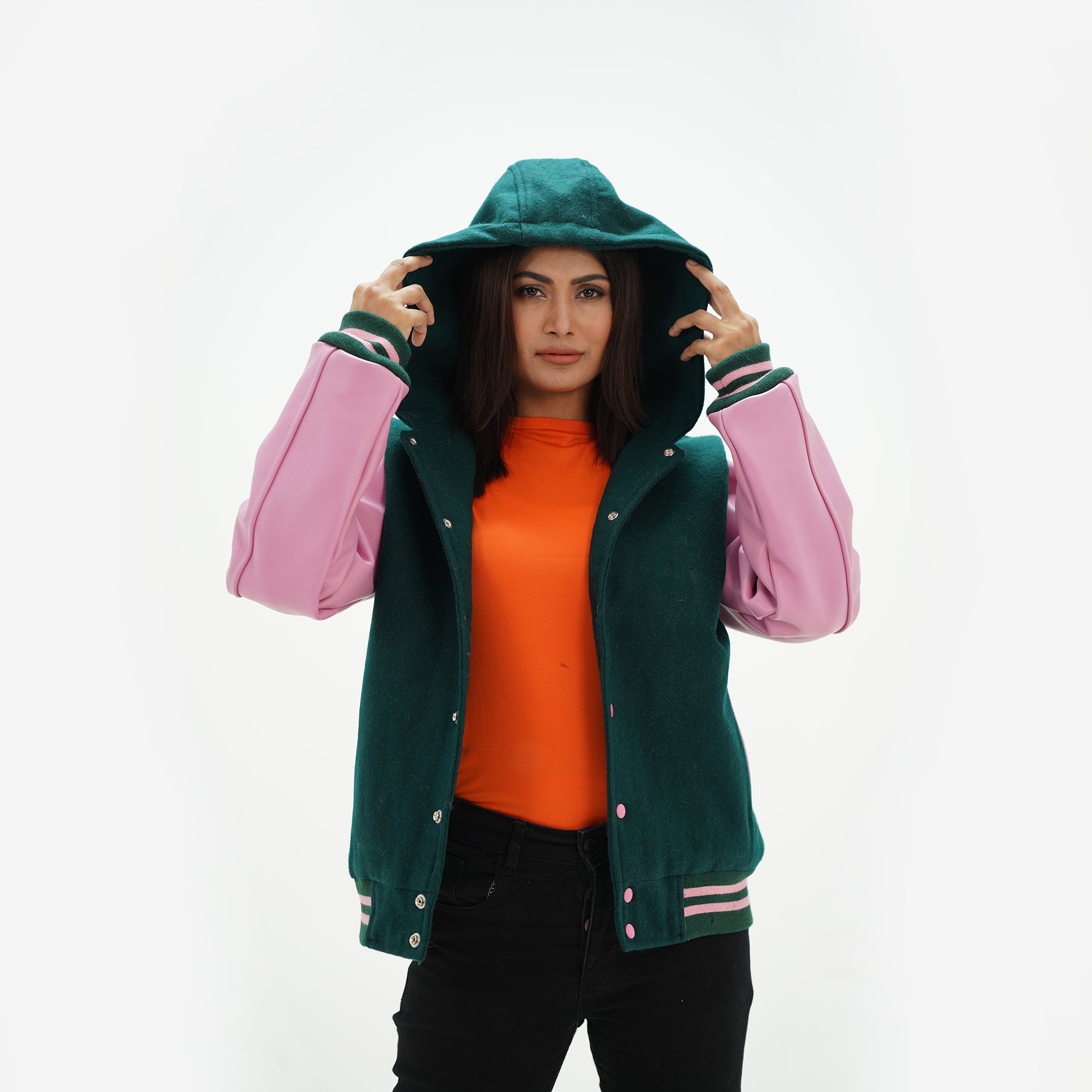 Close-up of drawstring hood and ribbed collar on dark green varsity jacket with white leather sleeve contrast