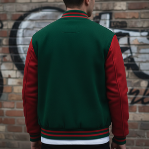 Person wearing a green and red varsity jacket against a graffiti-covered brick wall.