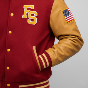 Red and gold varsity jacket with 'FS' logo and American flag patch on a gray background