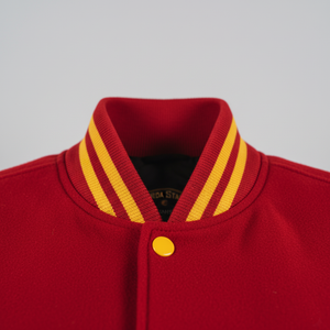 Red jacket with yellow trim collar on a gray background