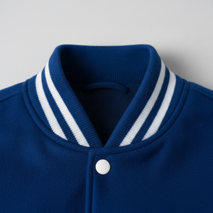 Close-up of a blue jacket with white striped collar on a light gray background