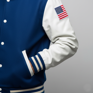 Navy and white varsity jacket with American flag patch on gray background