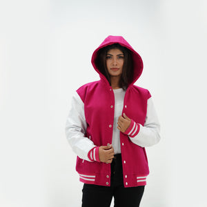 Three-quarter angle of girls pink hooded varsity jacket with white leather sleeves showing wool body construction