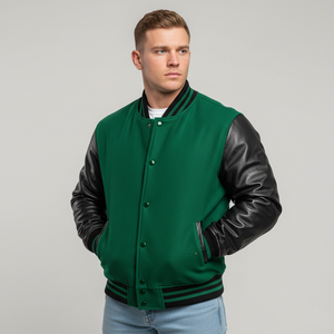 Man wearing a green varsity jacket with black sleeves on a gray background