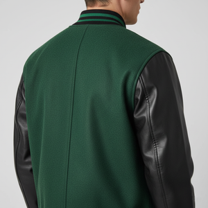 Green vest with black leather sleeves worn by a person on a gray background