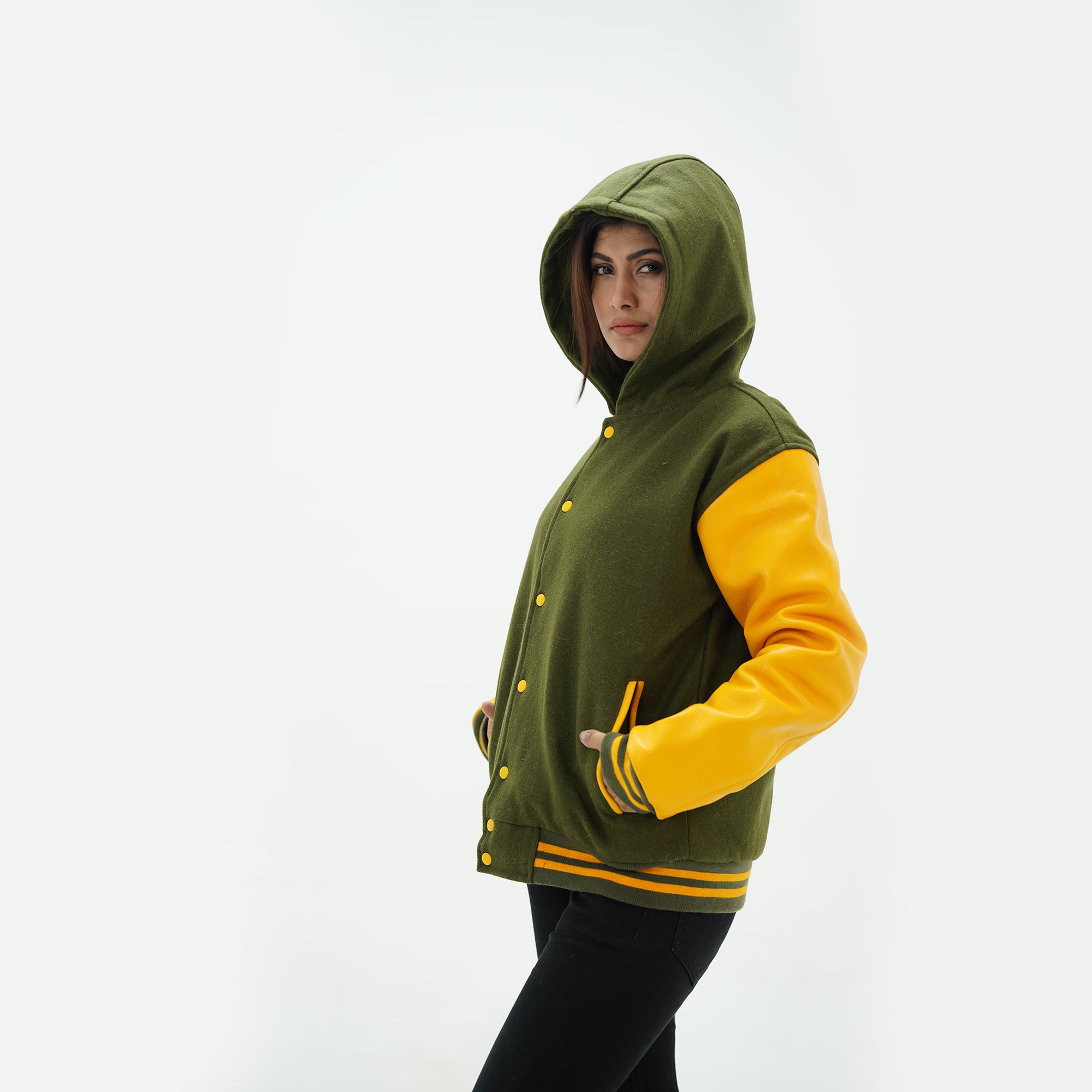 Detail shot of white leather sleeve with green yellow striped ribbed knit cuffs on hooded varsity jacket