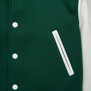 Close-up of a green varsity jacket with white buttons and a pocket.