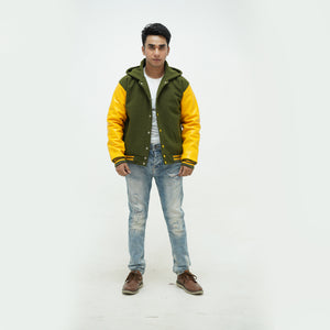 Close-up detail of green and yellow coach jacket with hood featuring premium cotton rib trim and wool construction