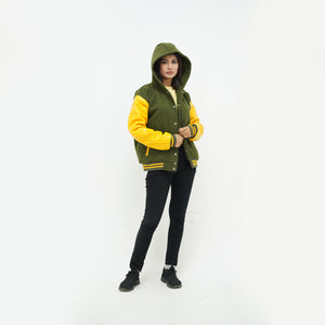 a girl wearing green and yellow letterman jacket hoodie in  white background
