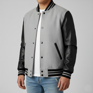 Gray varsity jacket with black sleeves and trim on a gray background