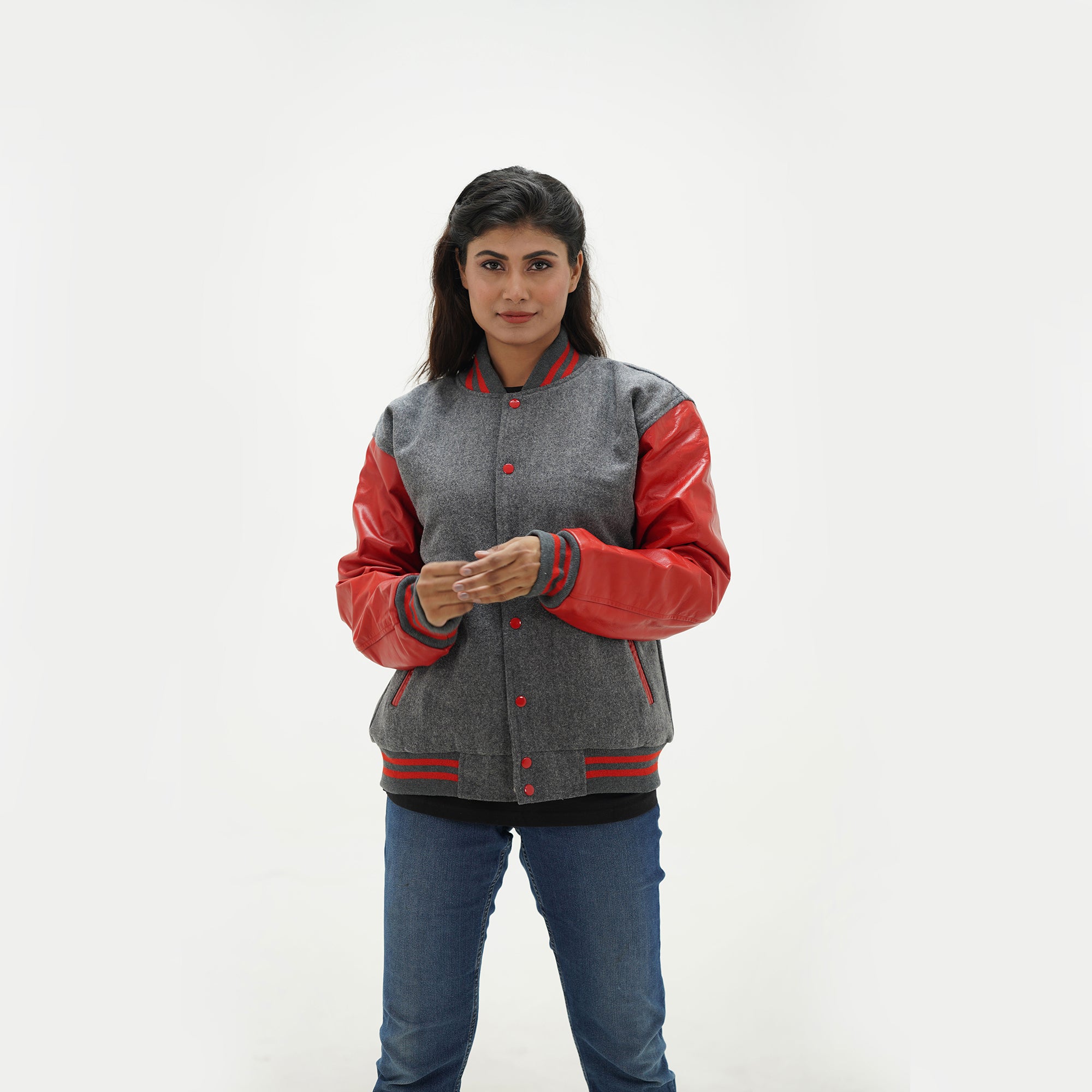 Close-up detail of grey Melton wool and red leather sleeve connection on women's varsity jacket with ribbed trim accents